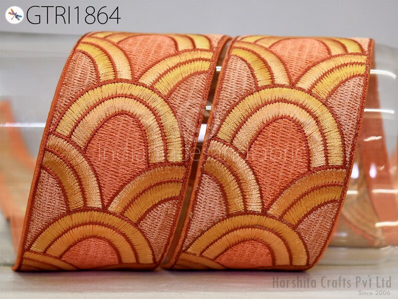 a decorative fabric with a repeating pattern of orange and yellow circles, creating a visually appealing design.