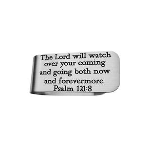 May include: A silver-colored money clip with the text "The Lord will watch over your coming and going both now and forevermore Psalm 121:8" engraved on the front. The clip has a curved design.