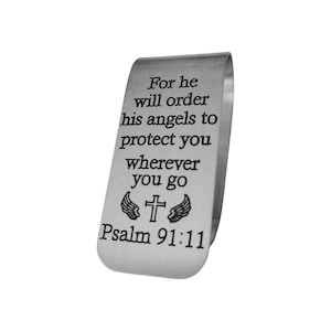 May include: A silver-colored money clip with the text "For he will order his angels to protect you wherever you go Psalm 91:11". The clip features a cross and wing design.