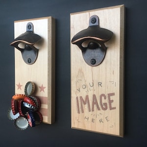 May include: Two wooden bottle openers with a metal bottle opener attached to each. The bottle opener on the left has a red, white, and blue design with bottle caps attached to it. The bottle opener on the right has the text "YOUR IMAGE HERE" printed on it.
