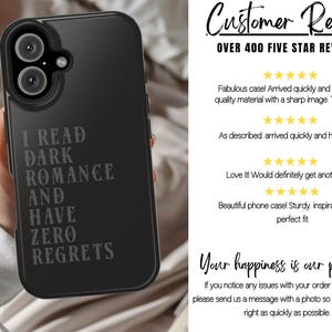 May include: Black phone case with the text "I READ DARK ROMANCE AND HAVE ZERO REGRETS" in a gray font. The phone case has a camera cutout and is held by a person.