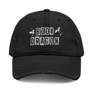 May include: Black distressed baseball cap with white text that reads "BOOK DRAGON" and a small graphic of a dragon.