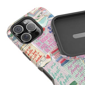 May include: A phone case with a colorful design featuring books, hearts, and glasses. The case has the text "IN BOOKS ARE JUST BETTER" and "life is better in bed with a book". The case is black and gray.