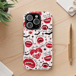 May include: A phone case with a repeating pattern of red lips, vampire fangs, bats, and text on a white and pink striped background. The text includes phrases like "bite club dropout" and "mind your neck."