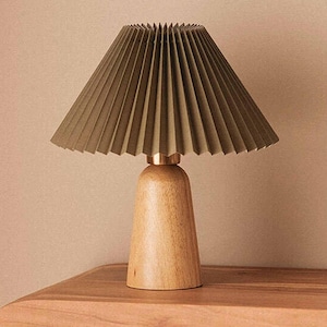 May include: A handmade wooden sign with the text "Welcome" in a playful font. The sign features a distressed finish and a simple, rustic design, perfect for a front door or entryway. The sign is approximately 12 inches wide.