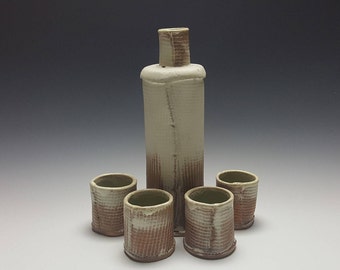 Large sake set by Potteryi. Handmade ceramic sake set with textured body.