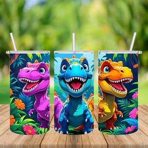 May include: Three stainless steel tumblers with dinosaur designs. Each tumbler showcases a different dinosaur in bright colours: purple, blue, and orange. The background includes tropical foliage and flowers, with a straw in each tumbler.