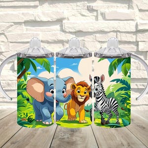 May include: Three baby sippy cups with jungle animal illustrations. Each cup features a different animal: an elephant, a lion, and a zebra. The cups have clear lids and handles, with a jungle background of green foliage and blue sky.