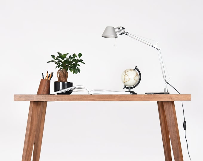 Small modern desk in walnut with a black top in Mid Century style