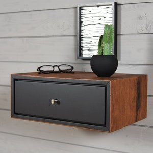 black floating bedside table with 1 old wooden box