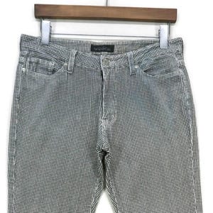 May include: Black and white checkered flared pants. The pants have a wide leg opening and a classic five-pocket design.