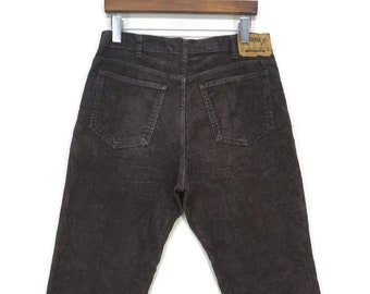 May include: Dark brown corduroy pants with a brown leather patch on the back pocket that says "RANGER CO."