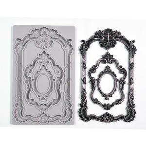 May include: A silicone mold for baking or crafting, featuring a design of a set of three ornate frames. The mold is gray and the frames are detailed with intricate scrollwork.