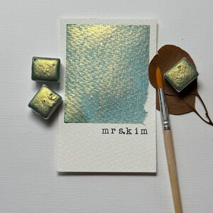 Mrs. Kim is a green gold  shimmer  watercolor paint half pan for calligraphy, art, crafts, lettering, pointed pen, detail art