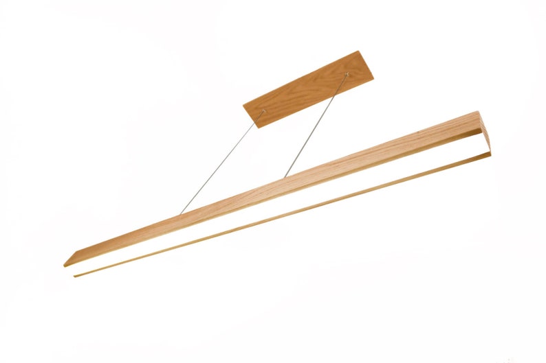 May include: A modern, rectangular wooden pendant light fixture. The light has a natural wood finish and a bright, linear LED light source. It is suspended from the ceiling by thin metal cables and a rectangular wooden mounting plate.