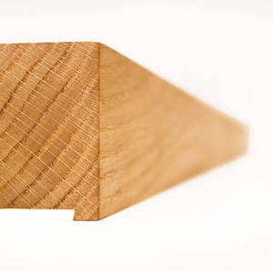May include: Close-up of a section of a light brown wooden beam. The end of the beam is square with a notch cut out of the bottom. The wood grain is visible, showing the natural texture and pattern of the wood.