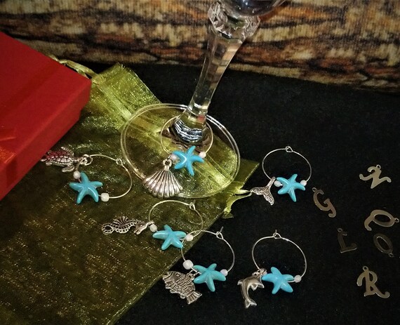 GLASS BEAD RING 2 MM CHAMPAGNE MIX W/STAR CHARM GLASS BEAD RING 2 MM CHAMPAGNE MIX W/STAR CHARM