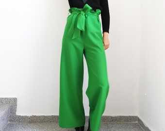 May include: Green wide-leg pants with a large bow at the waist.