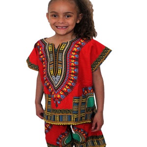 May include: Red and green patterned dashiki shirt and shorts set for children. The shirt has a V-neck and short sleeves. The shorts have an elastic waistband.