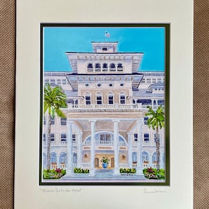 May include: A watercolor painting of the Moana Surfrider Hotel in Honolulu, Hawaii. The hotel is a white building with a green roof and a large porch. The painting is signed "Laurel Wiens".