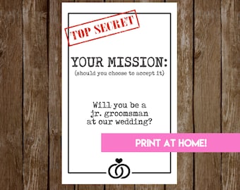 May include: A black and white invitation with the text "TOP SECRET" and "YOUR MISSION: (should you choose to accept it)". It asks "Will you be a jr. groomsman at our wedding?" with a pink "PRINT AT HOME!" button.
