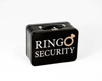May include: Black metal lunchbox with a white logo that says "RINGO SECURITY" and a gold ring symbol.
