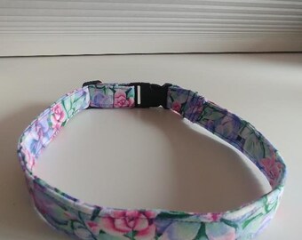 May include: A floral patterned dog collar with a black plastic buckle.
