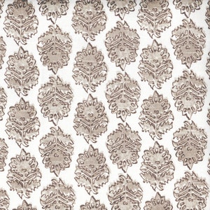May include: A seamless pattern of brown floral designs on a white background. The design is a repeating pattern of stylized flowers with intricate details.
