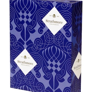 May include: A rectangular box with a repeating blue and light blue swirling pattern. The box features white diamond-shaped labels with the text "Strathmore" and "Mark of Quality". The Strathmore logo is also visible.