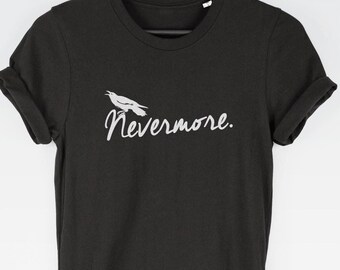 May include: A black short-sleeved t-shirt with rolled sleeves featuring a white graphic of a bird perched above the word Nevermore. The shirt is displayed on a black hanger against a plain background, showcasing a crew neckline and a simple design.
