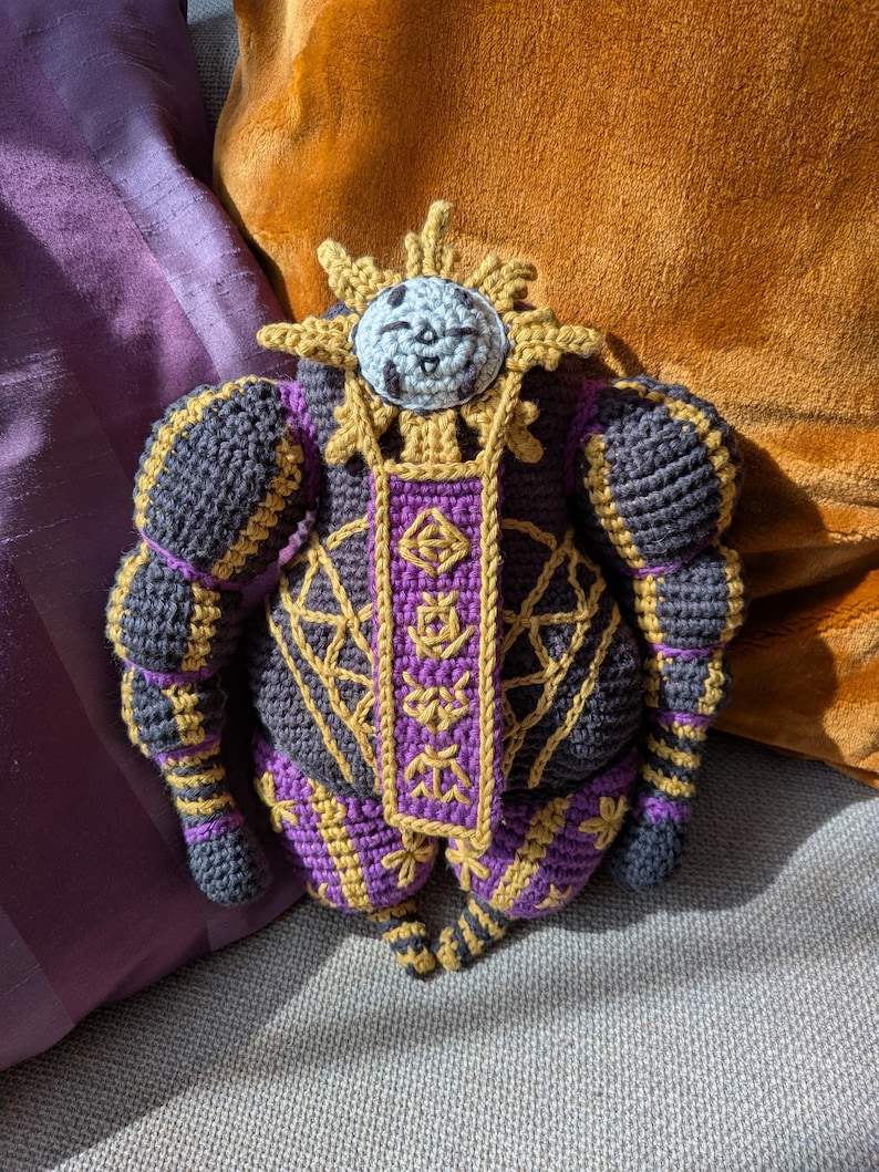 Finished Esquie crochet doll sitting upright, designed as a plush character from a fantasy game. Ideal for fans.