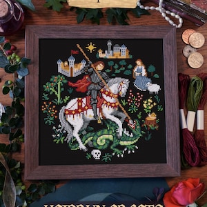 A cross-stitch pattern of St-Georges depicting the knight on horseback slaying a dragon. The pattern is set against a dark background with a medieval castle in the distance. The pattern is titled "PDF Pattern" and "Heidrun Crafts".