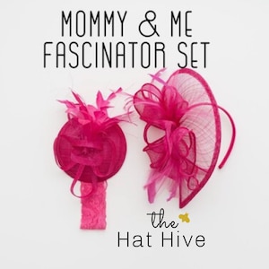 May include: A set of two pink fascinators, one larger with a headband and one smaller with a headband. The text "Mommy & Me Fascinator Set" and "the Hat Hive" is visible in the image.