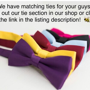 May include: A collection of five fabric bow ties in purple, yellow, burgundy, light blue, and black, arranged in a row. The text above reads: We have matching ties for your guys! Check out our tie section in our shop or click on the link in the listing description!