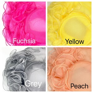 May include: Four different colored hats made of ruffled fabric. The hats are fuchsia, yellow, grey, and peach.