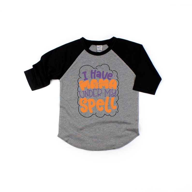 May include: A grey and black baseball tee shirt with the text "I have mama under my spell" in orange and purple lettering.