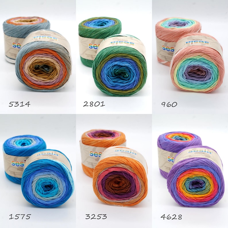 Puede incluir: Seis ovillos de hilo de colores con rayas de arco&iacute;ris. El hilo est&aacute; etiquetado como "Sesia Hide" y tiene los n&uacute;meros 5314, 2801, 960, 1575, 3253 y 4628.