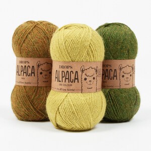 May include: Three skeins of yarn in green, yellow, and brown. The yarn is labeled "DROPS ALPACA" and is described as an "all-time favorite".