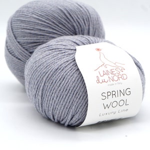 May include: Two skeins of light gray yarn with a white label that reads "Laines du Nord made in Italy Spring Wool Luxury Line" and "Colour 2".