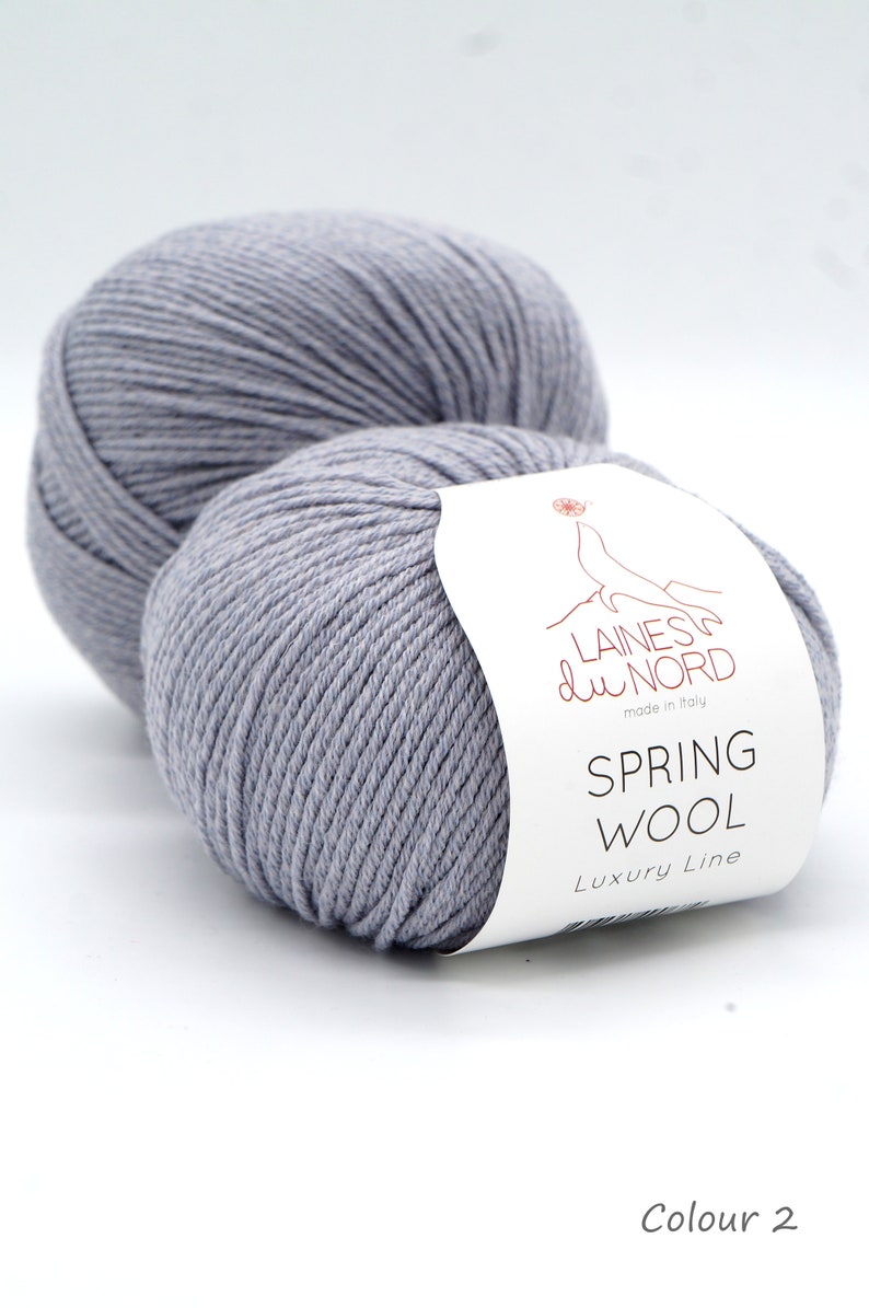 May include: Two skeins of light gray yarn with a white label that reads "Laines du Nord made in Italy Spring Wool Luxury Line" and "Colour 2".