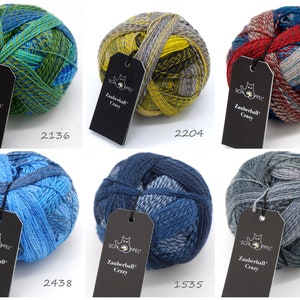 May include: Six balls of yarn in various color combinations, including blue, green, red, yellow, and gray. Each ball has a black tag with the text "Zauberball Crazy" and a number.