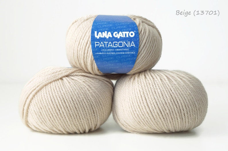 May include: Three balls of beige yarn labeled "Lana Gatto Patagonia" with the color code "Beige (13701)".