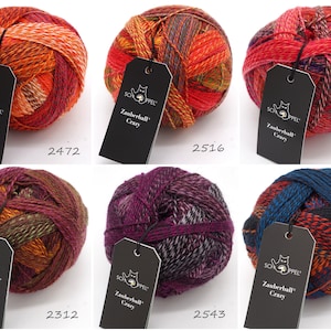 May include: Six balls of colorful yarn with black labels that say "Schappel Zauberball Crazy" and a number. The yarn is a mix of red, orange, purple, blue, and green.