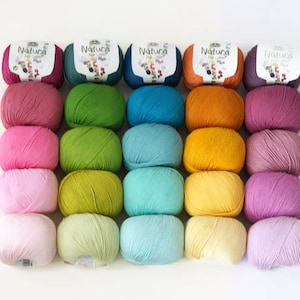 May include: A collection of 20 skeins of yarn in various shades of pink, green, blue, yellow, and purple. The yarn is arranged in rows of five, with each row featuring a different color. The yarn is labeled "Natura" on the skeins.