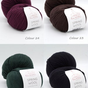 May include: Four skeins of yarn in different colors: burgundy, brown, dark green, and black. Each skein has a white label with the text "LAINES du NORD SPRING WOOL Luxury Line".