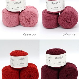 May include: Four balls of yarn in different shades of pink and red. The yarn is labeled "Ros&aacute;rios 4 Meia Classic Collection".