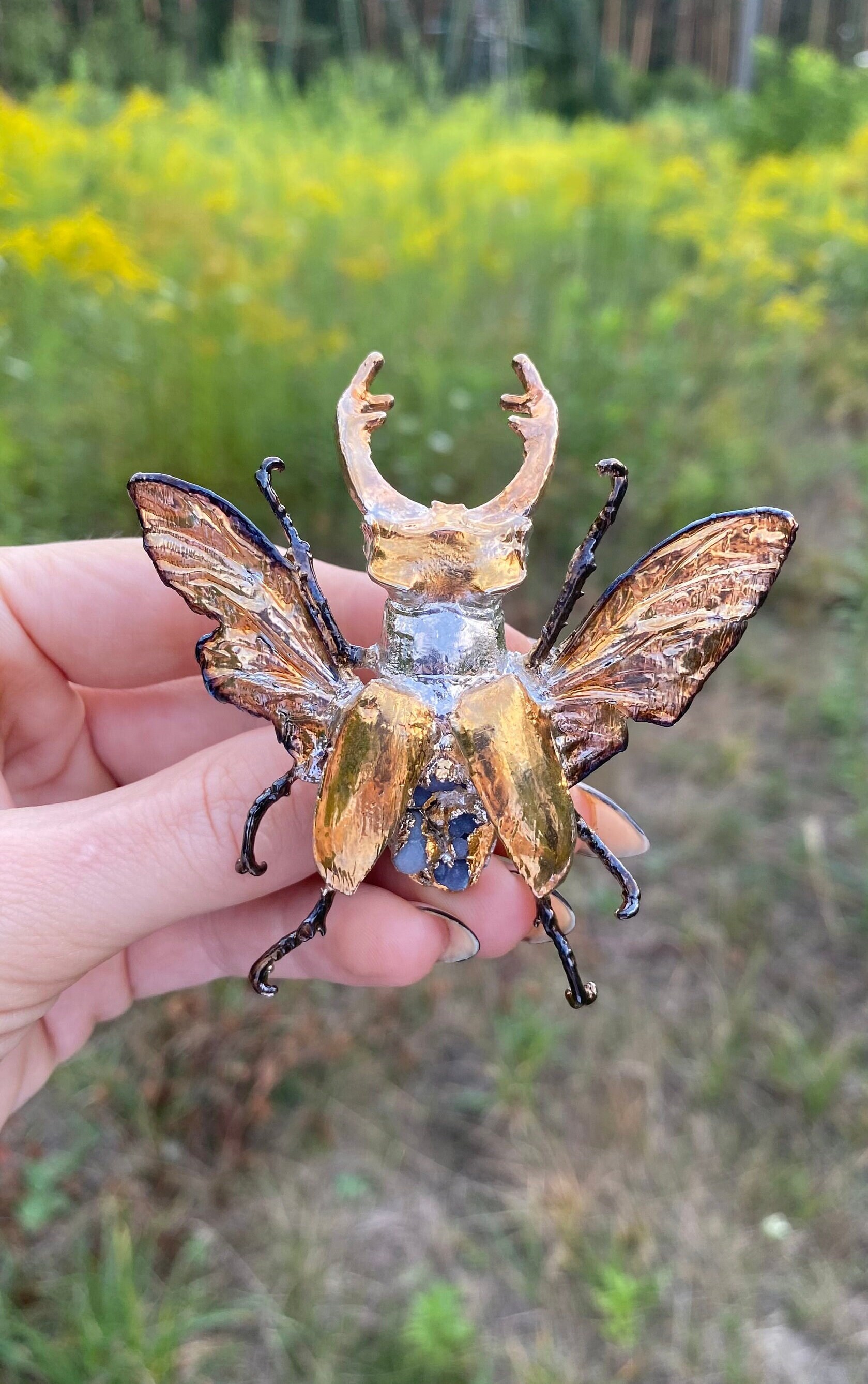 Unusual jewelry: real winged stag-beetle electroformed with pure rhodium finishing end gold