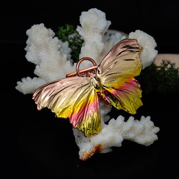 A real butterfly wing electroformed in copper — nature meets alchemy in wearable form, no two are identical.