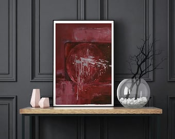 Puede incluir: Pintura abstracta en tonos rojos y blancos enmarcada en negro y colgada sobre una mesa consola de metal negro con tapa de madera. Un jarrón de vidrio transparente con piedras blancas se encuentra sobre la mesa.