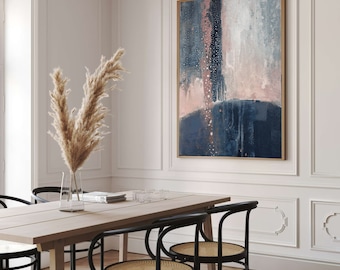 May include: A dining room with a wooden table and black chairs. A large abstract painting with pink, blue, and white colors hangs on the wall. A vase with dried pampas grass sits on the table.